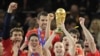 South Africa -- Spain's midfielder Andres Iniesta (C) raises the trophy as Spain's national football team players celebrate winning the 2010 FIFA football World Cup final between the Netherlands and Spain, 11Jul2010